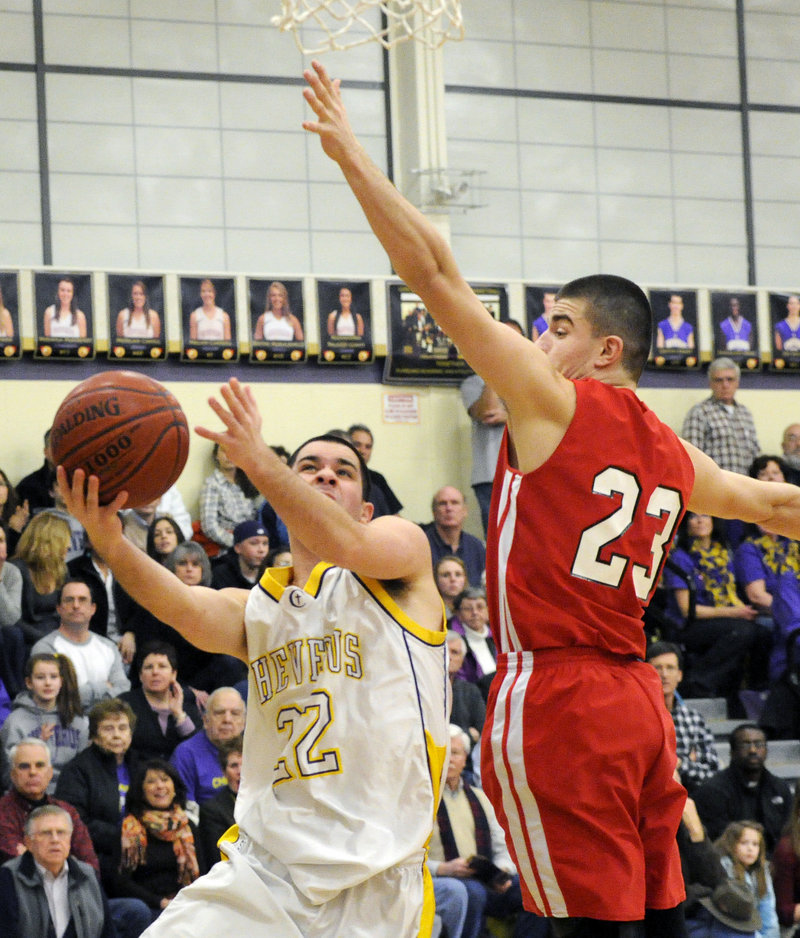 Joe Savino of Cheverus finds room to get off a shot while guarded by Vukasin Vignjevic of South Portland.