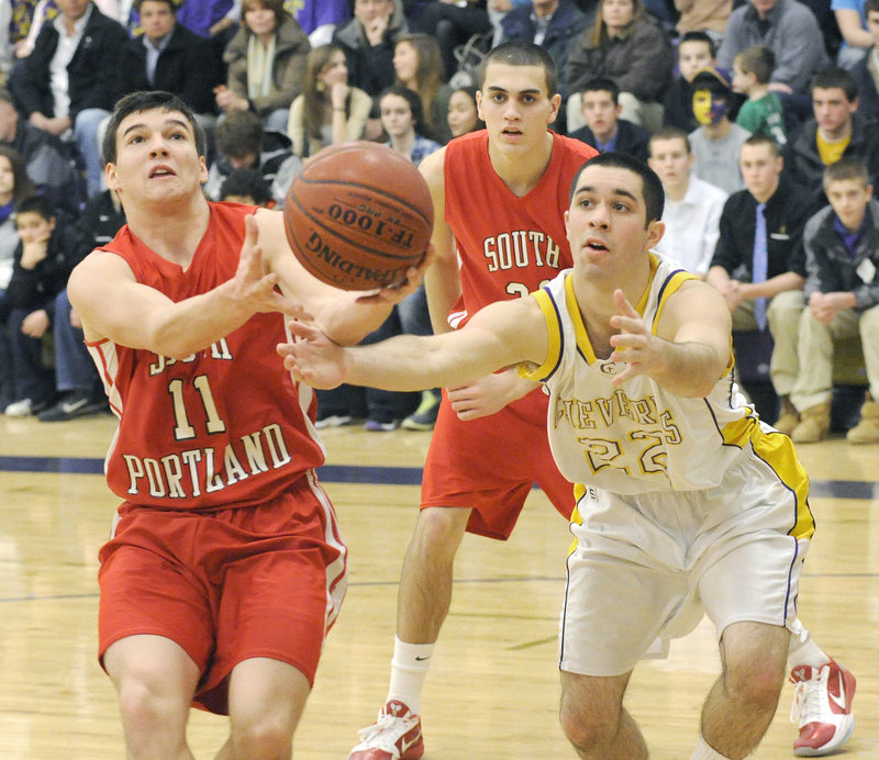 Steve Hodge of South Portland attempts to keep control of the ball Friday night as Joe Savino of Cheverus moves in during Cheverus 50-35 victory in a regular-season finale.