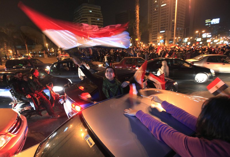 Egyptians thronged Tahrir Square in Cairo, waving flags and chanting slogans after President Hosni Mubarak resigned and handed power to the military Friday.