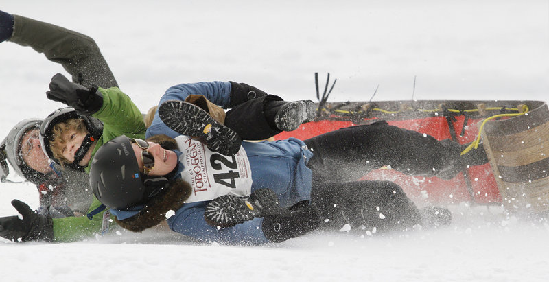 Team TNT, consisting of the Tanner family from New York City, wipes out at the end of the run during the 21st Annual U.S. National Toboggan Championships in Camden Saturday.