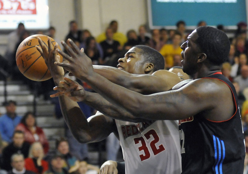 Deshawn Sims, left, of the Maine Red Claws stretches past Jamar Brown of Springfield to reach for a rebound during Maine’s 97-96 win on Sunday at the Portland Expo.