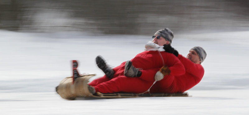 The Redneck Rocket Boys two-man sled team consisting of Mark Kelley of Hollis, in front, and Gary LaPerriere of Sanford races past the finish line on Saturday.