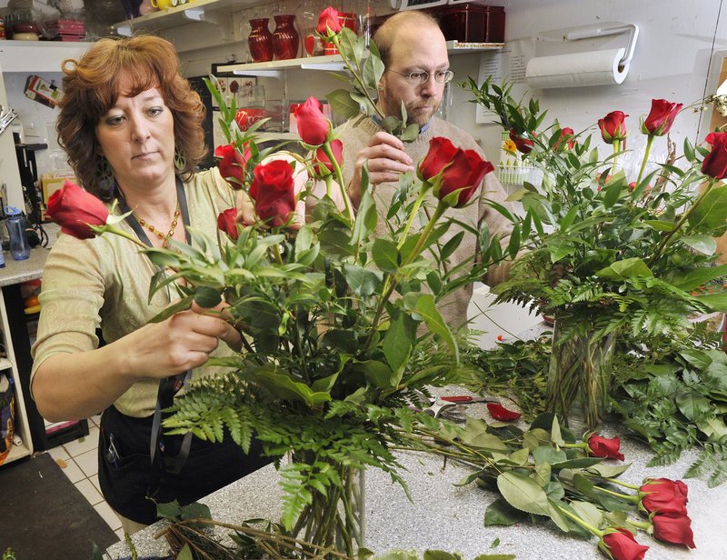Reporter Ray Routhier gets some flower arranging tips from Rhonda Davis at Harmon's & Barton's.