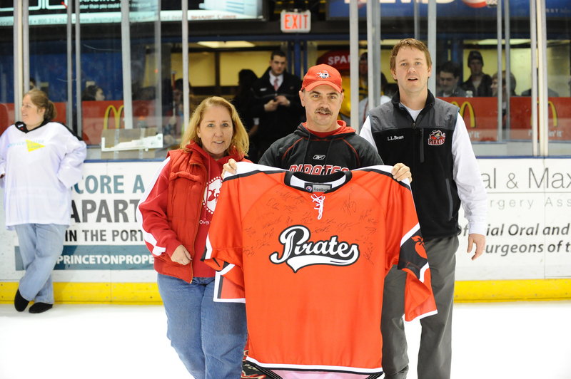 David Blake was the winner of the Portland Pirates autographed American Heart Association jersey on Saturday night. Blake won the grand prize as part of the heart association's Mystery Pucks Contest. Blake, middle, a heart disease survivor, is pictured with Carrie Fortino, executive director of the American Heart Association of Maine, and Todd Jamison, director of corporate sales for the Pirates.