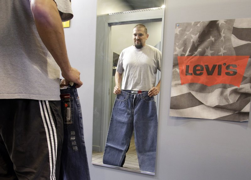 Brian Begay shops for a pair of Levi jeans at a store in Hayward, Calif. Apparel prices are expected to climb 10 percent in the coming months, analysts say, paced by the soaring cost of raw materials. Cotton has more than doubled in price in the past year.