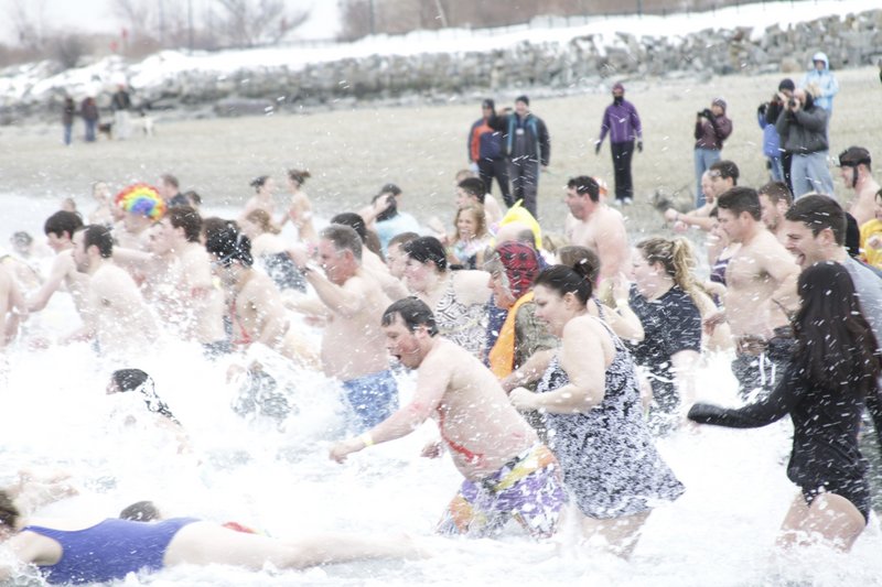 The Polar Dip gets under way Saturday at East End Beach on Casco Bay. It raised $10,000 more than last year.
