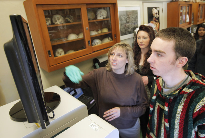 Jennifer Jamison and Deering sophomore Billy Farrell look at an image on a monitor connected to an electron microscope in a biology class at the high school Tuesday. Jamison is a microscopist and research associate at the University of Southern Maine.