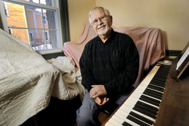 John Linscott of Portland sits at the piano in his music room, which is being remodeled. Linscott has been writing plays for years and lately is getting attention for a song he wrote about whoopie pies, the dessert that has been nominated for designation as Maine's official state treat.