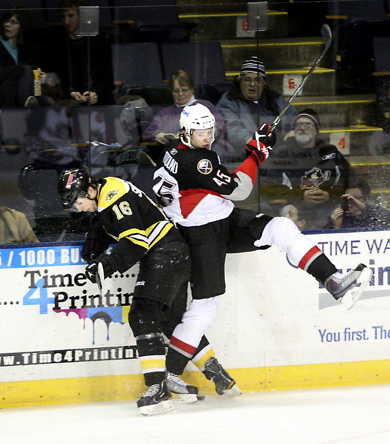 Photos by Tim Greenway/Staff Photographer Nick Tuzzolino, right, of the Pirates battles for the puck with Jordan La Vallee-Smotherman of the Bruins during a game Wednesday night at the Cumberland County Civic Center.