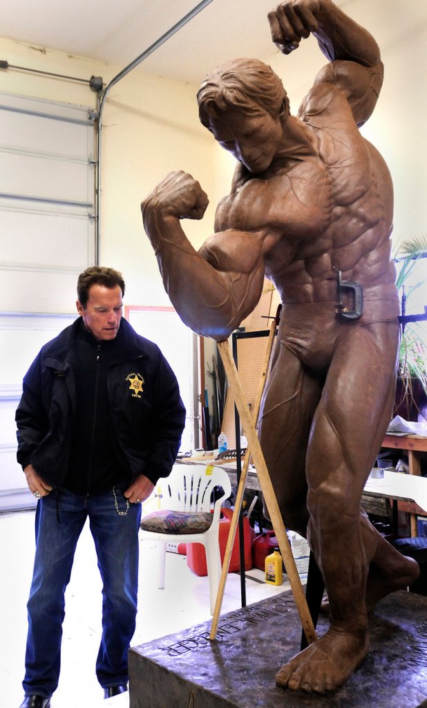 Arnold Schwarzenegger checks out the clay sculpture in Lewiston, Idaho.