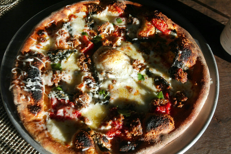 This egg-topped pizza is ready to be served at Hudson restaurant in Oakland, Calif.