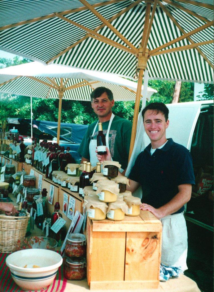 Jim Stott, left, and Jonathan King sell sauces on opening day at a farmer’s market in 1991, the start of Stonewall Kitchen.