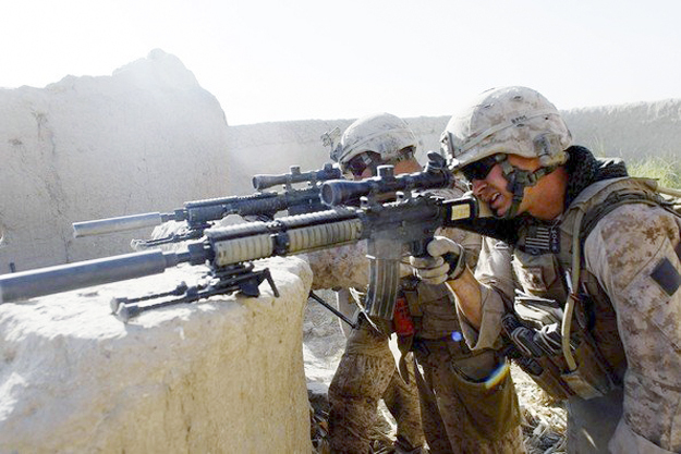 Marine Sgt. John Spring Jr. fires his rifle during the U.S. surge into Helmand province in Afghanistan. Spring was awarded the Bronze Star for heroism.