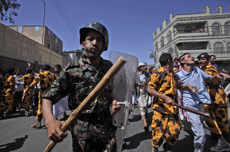 Yemeni riot police charge toward anti-government demonstrators who took to the streets of San'a on Friday to demand the resignation of President Ali Abdullah Saleh.