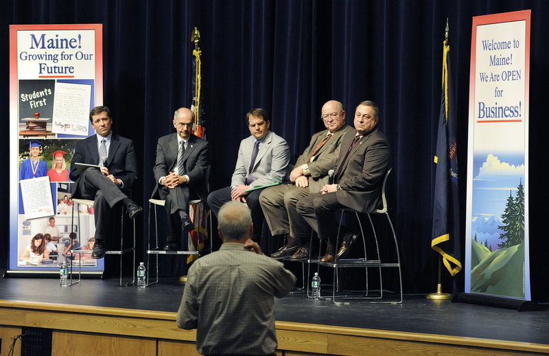Gov. Paul LePage, at right, and from left, Education Commissioner-nominee Steve Bowen, DEP Commissioner Darryl Brown, Economic Development Commissioner David Bernhardt and Transportation Commissioner Phil Congdon listen to a question as they hold a “Capitol for a Day” town hall meeting Friday at the Westbrook Performing Arts Center.