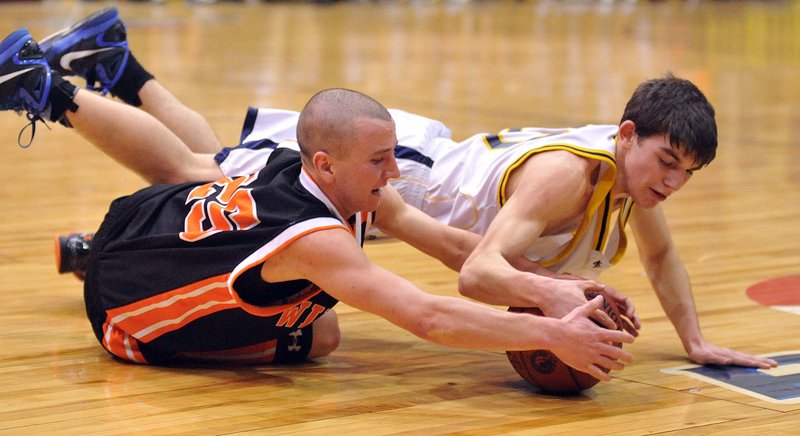 Justin Murray, left, of Winslow and Deering Genthner of Medomak Valley dive for a loose ball in the second quarter of their Eastern Class B quarterfinal. Murray scored 30 points for the Black Raiders.