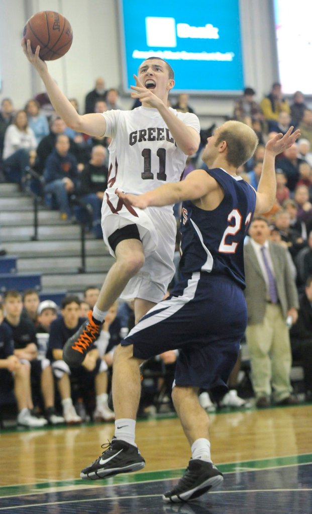 Nick Clark of Greely hits on a fast break as Nick Bennett of Gray-New Gloucester defends. Greely won, 78-56.