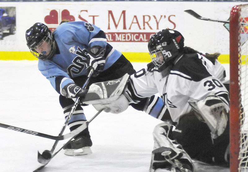 York's Victoria Stocks has her shot blocked by St. Dom's goalie Nicole Keaney during the girls' hockey state championship game in Lewiston on Saturday night. St. Dom's won, 6-1.