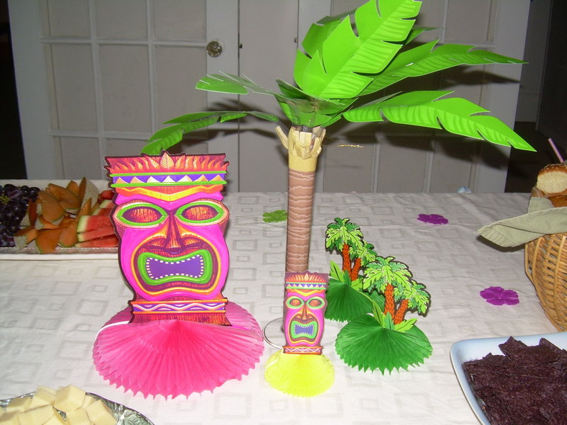 Tiki table decorations don't have to be expensive, and add color and the illusion of getting away from the winter. Besides, who's going to argue with that mask?