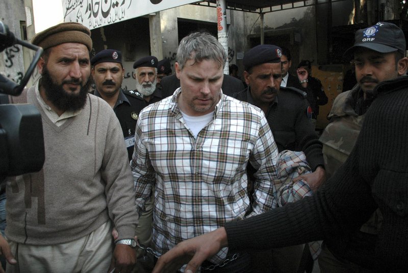 Pakistani security officials take Raymond Allen Davis to a court in Lahore. Davis’ arrest last month for allegedly shooting two Pakistanis has caused a diplomatic crisis.