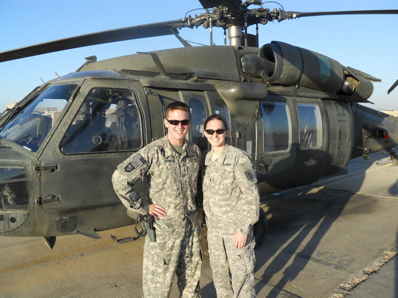 Ashley Pringle, right, a 2004 Lake Region High School graduate, and her husband, Anthony, in front of a helicopter at Camp Taji, located north of Baghdad in Iraq.