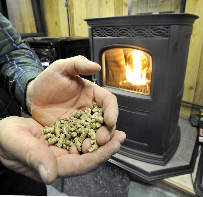 Frost and Flame owner Stephen Richard displays wood pellets at his Gorham store.
