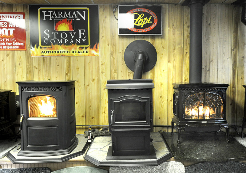 Two pellet stoves and a gas stove, at right, are on display at Frost and Flame in Gorham. The company’s sales declined during the recession, but have risen 15 percent this year.