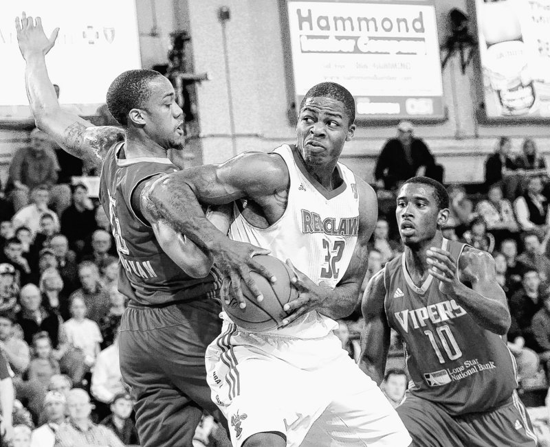 DeShawn Sims, who scored 30 points Thursday for the Red Claws, moves against Patrick Sullivan, left, and Terrel Harris of the Rio Grande Valley Vipers in the Vipers 107-101 victory.