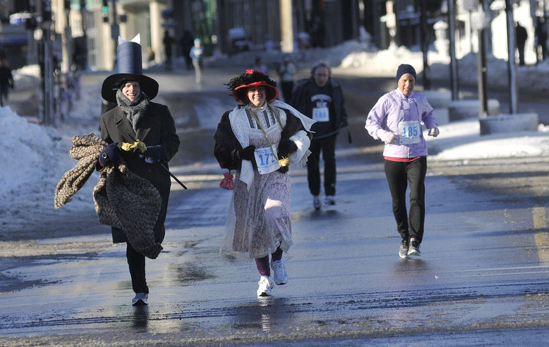 In period costumes, Mike Miller and Laura Jean Wilcox, both of Seattle, run toward the finish line during the February Frostbite 2.5K in Portland on Saturday. The couple were visiting Wilcox's parents, who are members of the Longfellow Chorus.