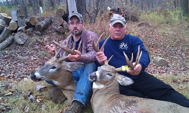 Everett T. Leonard, left, and his father, Everett H. "Lenny" Leonard, both of Turner, pose with two of the estimated 32 deer they and three other Mainers are alleged to have shot illegally late last year in northeast Pennsylvania.