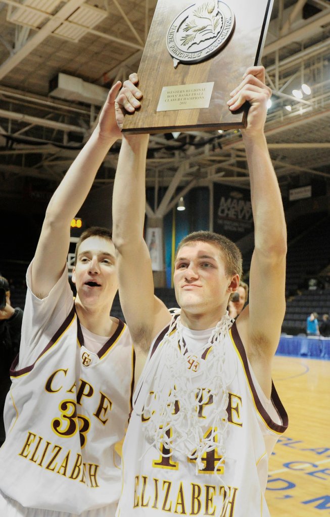 Cape Elizabeth captains Theo Bowe, left, and Joey Doane hold up the Western Maine Class B boys basketball trophy following the team's 61-47 win over Yarmouth Saturday in Portland. Doane scored 20 points while Bowe, the tourney MVP, added 19 as Cape won its third regional title in four seasons.