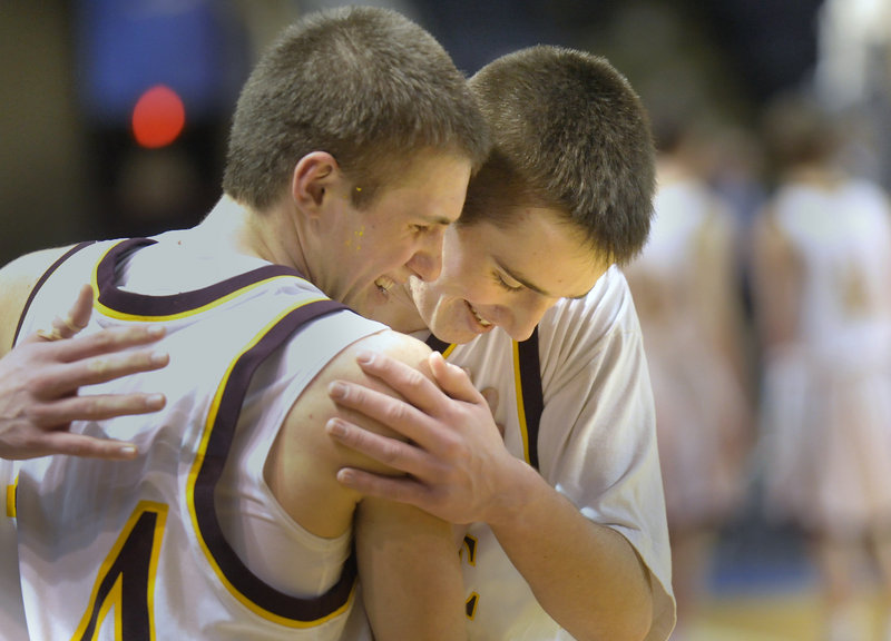 Joey Doane, left, and Theo Bowe, who combined for 39 points for Cape Elizabeth, embrace after the Capers returned to the top in Western Class B after losing to Falmouth a year ago. Cape beat Yarmouth 61-47 at the Cumberland County Civic Center.