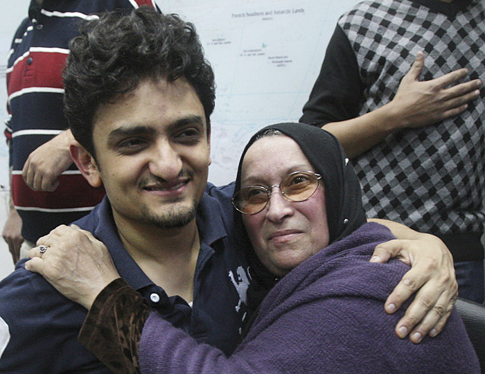 Egyptian Wael Ghonim, a Google Inc. marketing manager, who has become a hero of the demonstrators since he went missing on Jan. 27, two days after the protests began, hugs the mother of Khaled Said, a young 28-year-old businessman who died in June 2010 at the hands of undercover police.