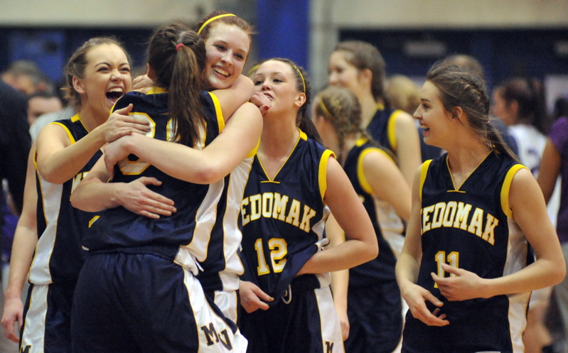 Medomak Valley players celebrate after their 54-36 victory Wednesday afternoon against John Bapst in an Eastern Class B semifinal.