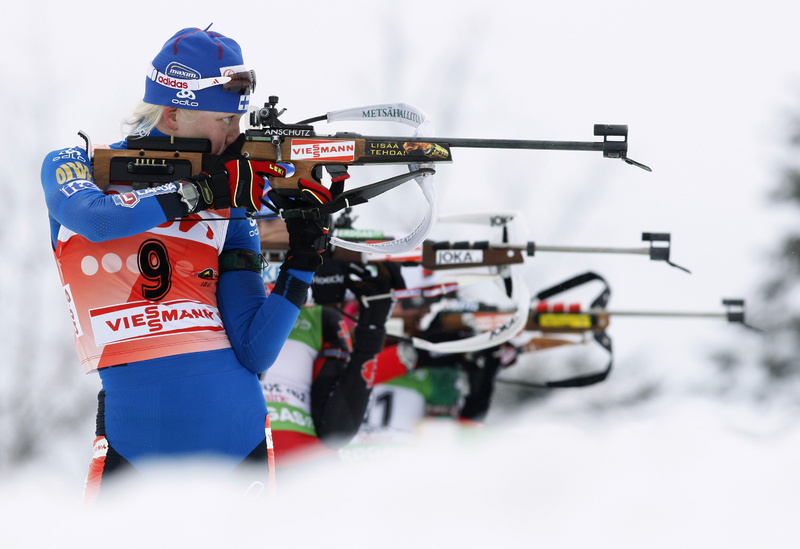 Kaisa Makaraine of Finland and other competitors take aim on the shooting range during the women’s 10K pursuit at the biathlon World Cup event Sunday in Presque Isle.