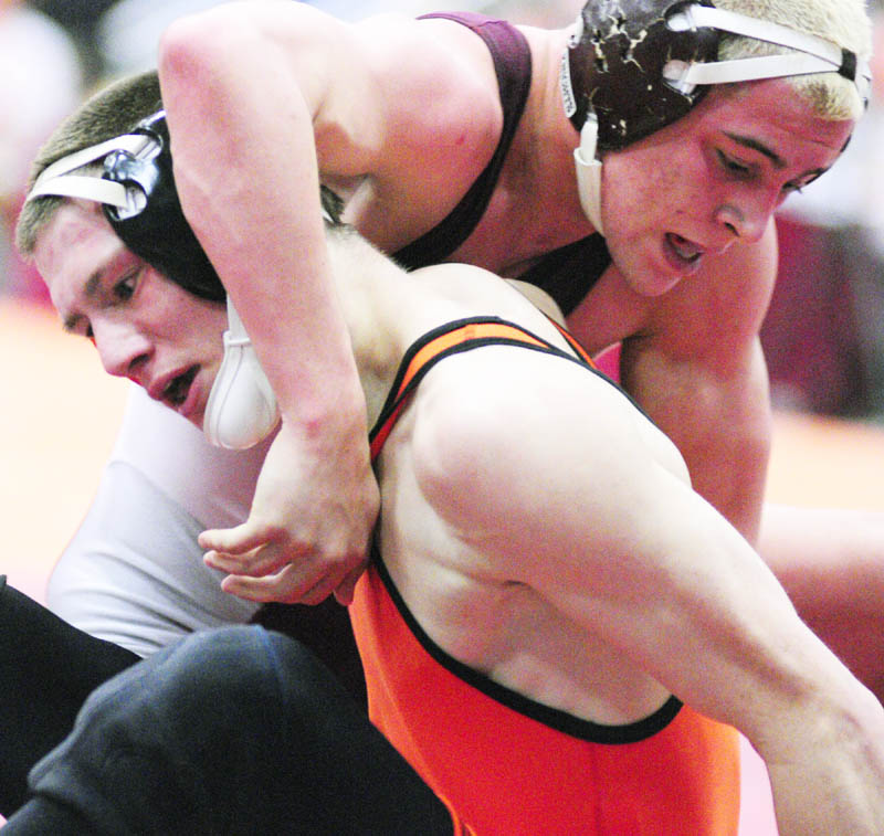 BATTLE IT OUT: Skowhegan’s Kaleb Austin, bottom left, grapples with Noble’s Ben Valencia in the 140-pound Class A championship match Saturday night during the wrestling state championships in the Augusta Civic Center. Valencia pinned Austin to win the title.