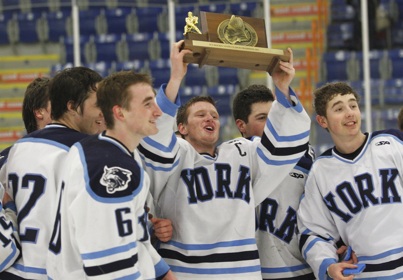 Anthony Figlioli hoists the state championship trophy while celebrating with teammates after defeating Brewer 4-3 in overtime. Figlioli scored the two goals including the winner.