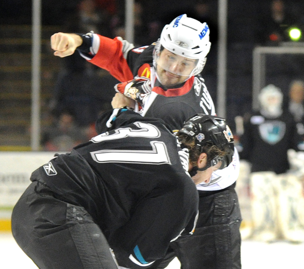 Colin Stuart of the Portland Pirates, top, mixes it up with Sean Sullivan of the Worcester Sharks on Tuesday at the Cumberland County Civic Center.