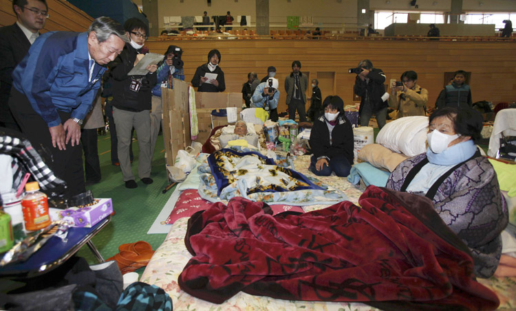 Norio Tsuzumi, vice president of Tokyo Electric Power Co., left, apologizes to evacuees at an evacuation center in Tamura of Fukushima Prefecture, Japan, today. Public sentiment is such that Fukushima's governor Yuhei Sato rejected a meeting offered by the president of Tepco, the utility that runs the Fukushima nuclear plant. "Considering the anxiety, anger and exasperation being felt by people in Fukushima, there is just no way for me to accept their apology," said Gov. Sato on national broadcaster NHK.