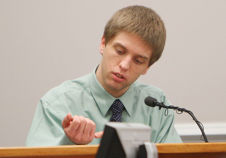 Christopher Gribble shows how he adjusted his grip on a knife as he attacked 11-year-old Jaimie Cates during his testimony on March 15, 2011, in Nashua, N.H.