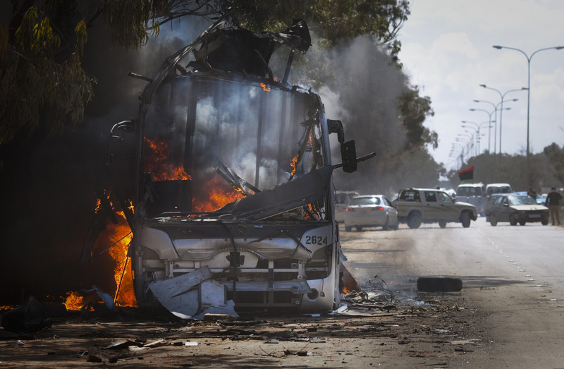 A bus burns on a road leading to the outskirts of Benghazi, eastern Libya, today.