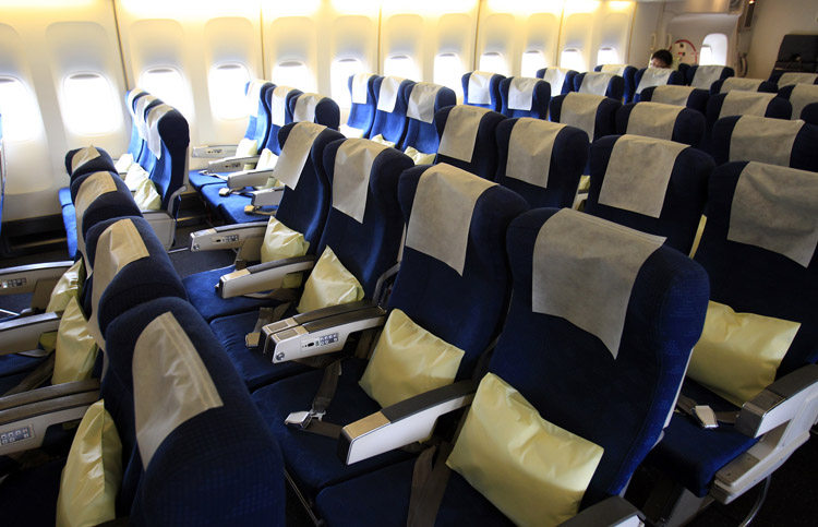 Seats are almost empty in a flight bound for Tokyo from Kimpo, South Korea, on Tuesday. Images broadcast worldwide of Japan's crippled nuclear complex and reports of food and water contaminated by radiation have battered its reputation as a safe destination, triggering an avalanche of cancellations by foreign tourists.
