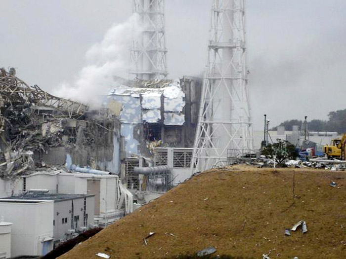 In this image released by Tokyo Electric Power Co., smoke billows from Unit 3, left, at the Fukushima Dai-ichi nuclear complex in Okumamachi, Fukushima Prefecture, northeastern Japan. At right is Unit 4. Japan welcomed U.S. help today in stabilizing its overheated, radiation-leaking nuclear complex, and reclassified the rating of the nuclear accident from Level 4 to Level 5 on a seven-level international scale, putting it on a par with the 1979 Three Mile Island accident.