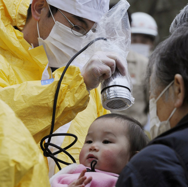 A baby is checked for radiation exposure level in Nihonmatsu in Fukushima prefecture today following a third explosion at the Fukushima Dai-ichi nuclear power complex.