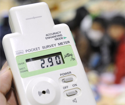 A pocket radiation detector shows a reading of 2.9 micro-sieverts per hour at an evacuation center in Koriyama for people living around the Fukushima Dai-ichi nuclear plant.