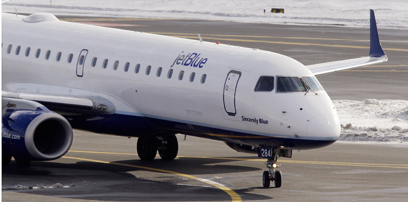 A Jet Blue jet taxis at Boston's Logan International Airport.