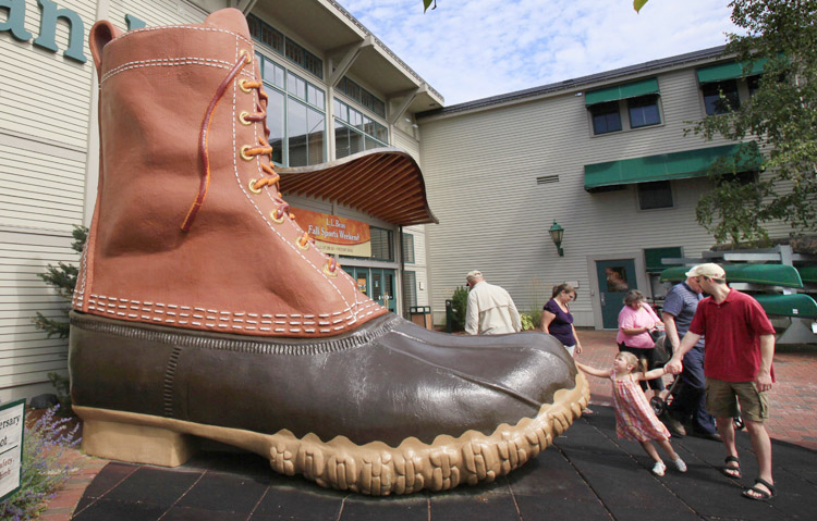Shoppers pause at the giant boot outside the L.L. Bean flagship store in Freeport. The company said "prudent forecasting and cost management" allowed it to minimize the impact of soft sales on overall profitability last year.