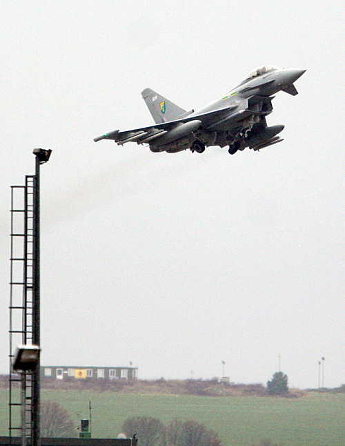 A British Typhoon jet fighter takes off from Gioia del Colle air base near Bari, southern Italy, today. The European Union's top foreign policy official brushed aside concerns today that the coalition supporting military action against Libyan leader Moammar Gadhafi is already starting to fracture, saying the head of the Arab League was misquoted as criticizing the operation.
