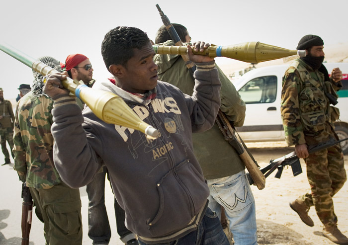 A Libyan rebels carries rockets on a checkpoint on the frontline near Zwitina, the outskirts of the city of Ajdabiya, south of Benghazi, eastern Libya, today.