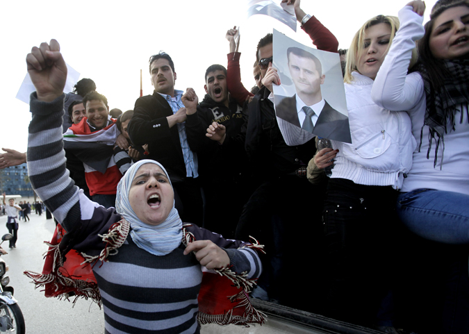 Protesters sympathetic to Syrian President Bashar Assad shout pro-Assad slogans during a demonstration in Damascus today.